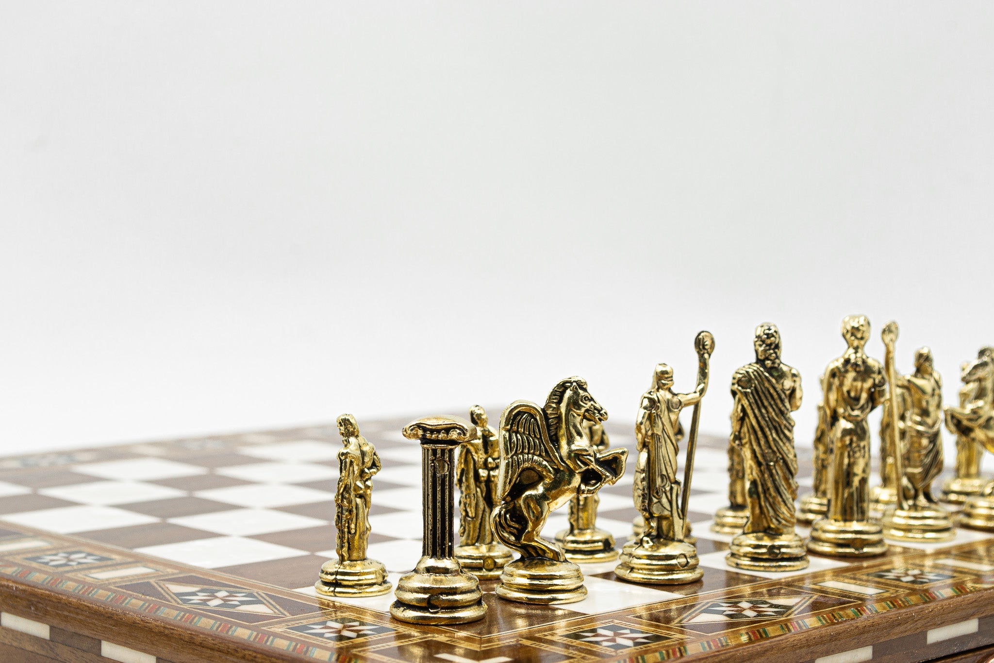 DALL-E, create an image of an ornate chess set arranged on a wooden table, with chess pieces made of sparkling crystal and gold, set in a luxurious, softly lit library with book-lined walls and a roar