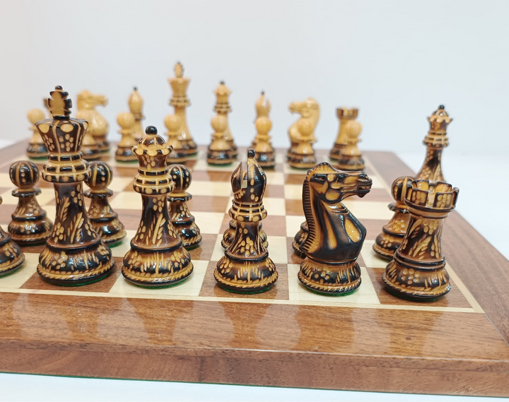 Close-up of hand-carved Burnt Staunton wooden chess pieces on a polished board, showcasing luxury craftsmanship.