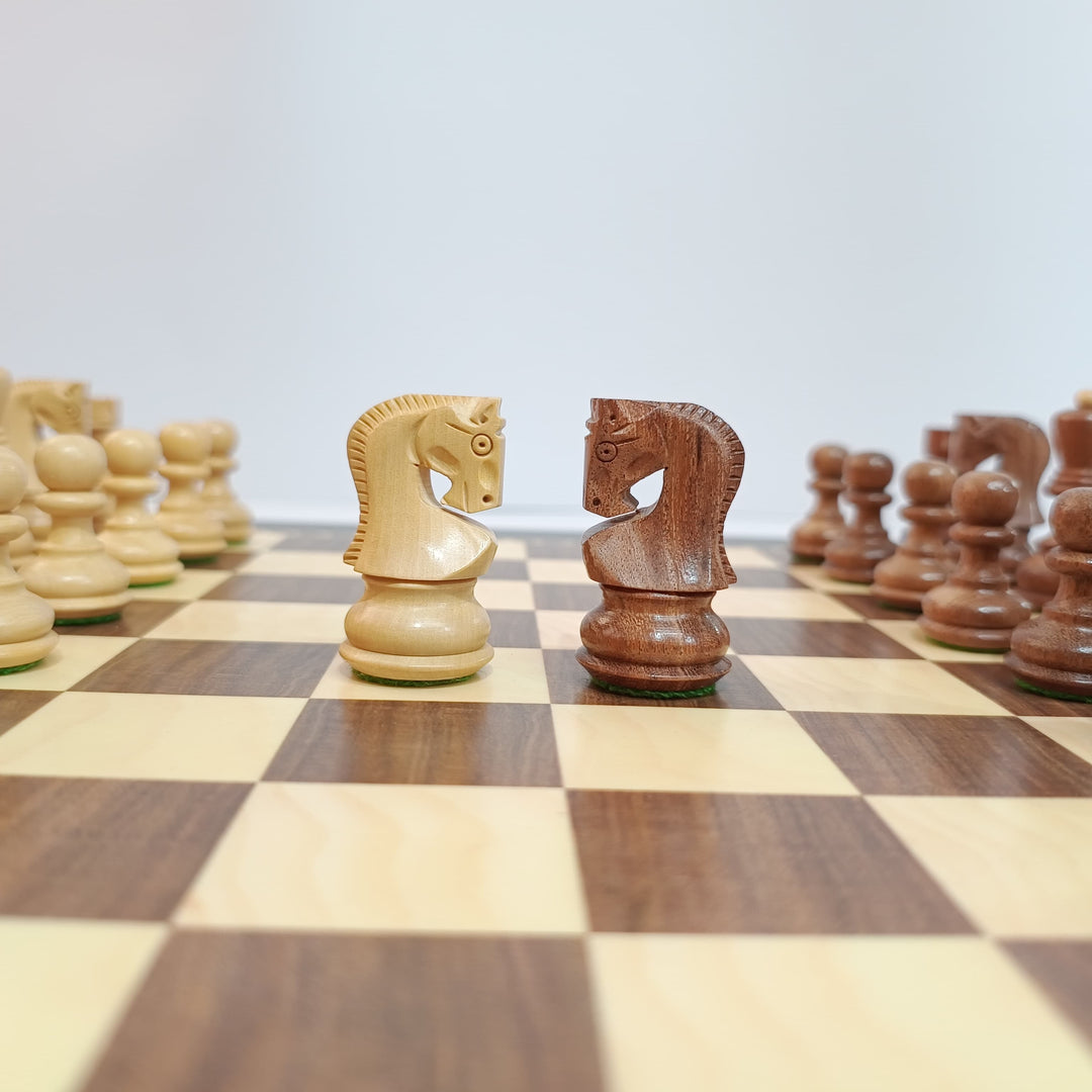 Two chess pieces, a white knight and a black knight, on a chessboard with a blurred background.