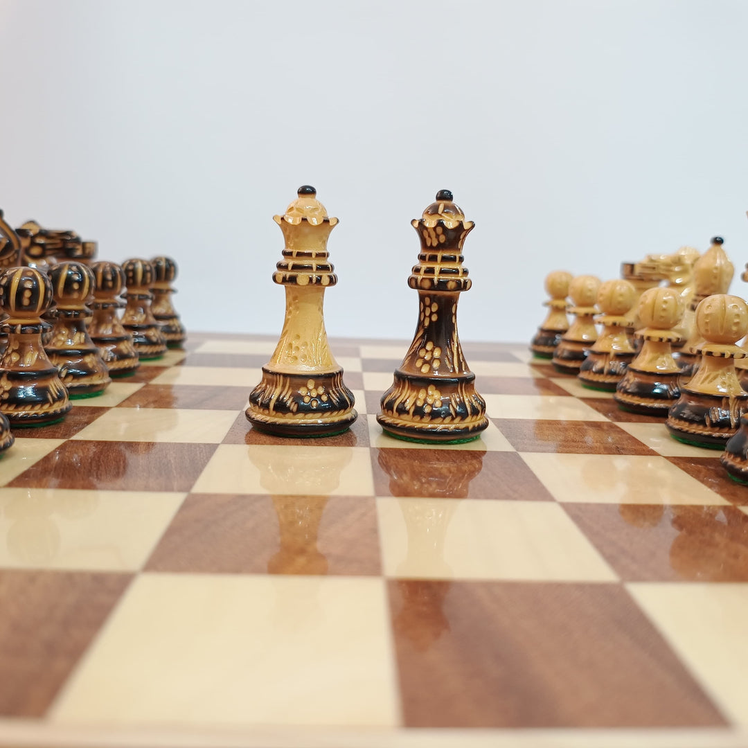 Hand carved luxury chess pieces on a professional chess board highlighting the kings and queens.