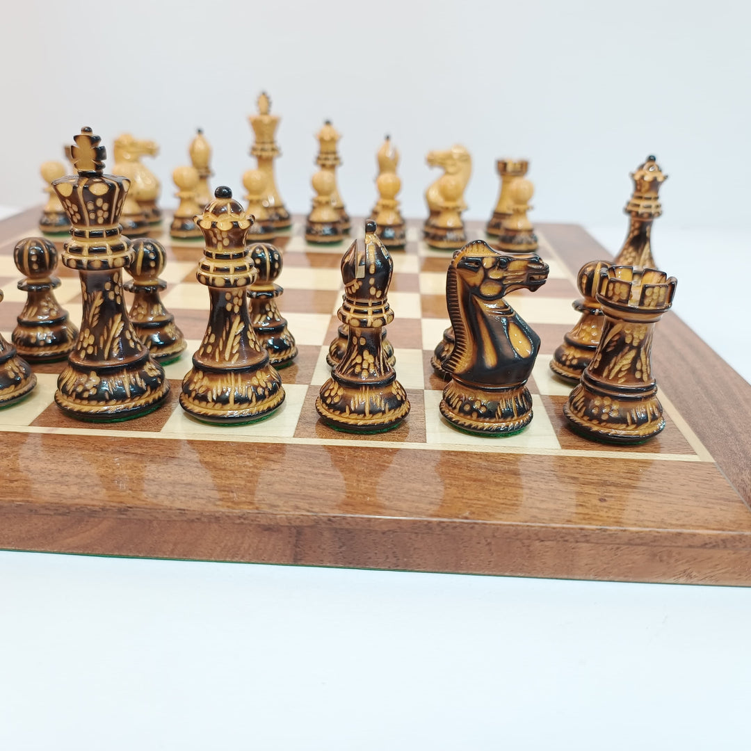 Classic Staunton burnt boxwood chess pieces on a wooden board, featuring a 3.9-inch King and intricately carved designs.